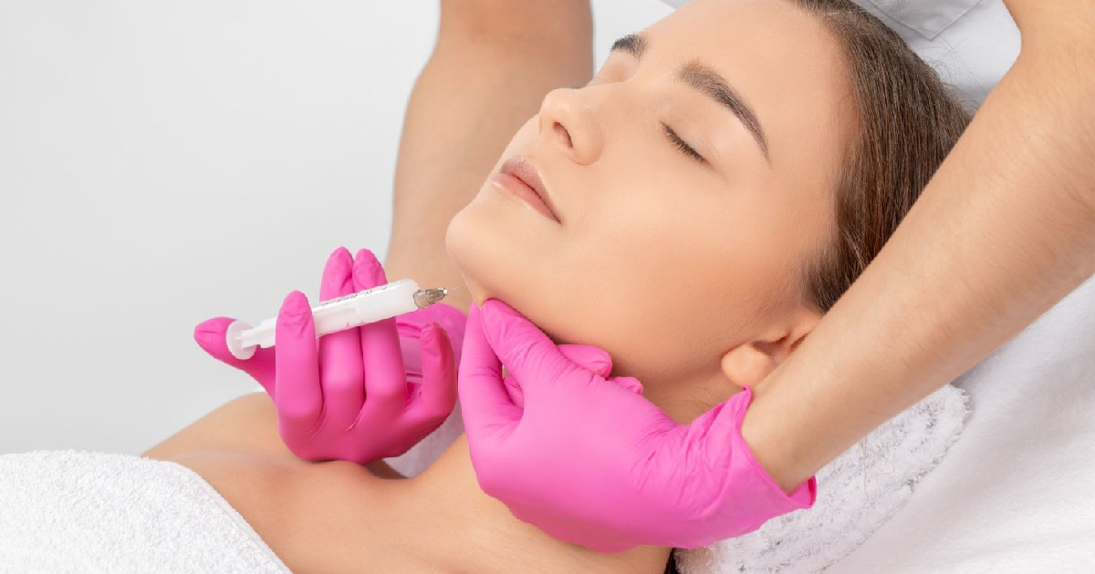 Woman receiving Kybella Treatment in Ankeny, IA for non-surgical double chin reduction.